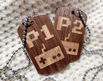 Conjunto de collares con forma de mando de videojuegos de madera para el jugador 1 y el jugador 2.