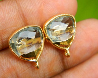 May include: Two gold-toned metal earring charms with clear faceted gemstone accents. Each charm has a loop at the bottom for attaching to jewelry.