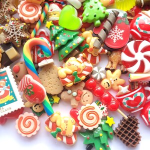 May include: Assortment of colorful Christmas-themed resin charms, including candy canes, gingerbread cookies, ornaments, and Santa Claus.