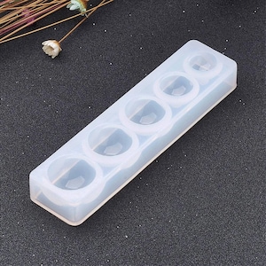 May include: A white silicone mould with six round cavities for making resin jewellery. The mould is made of flexible silicone and is easy to use.