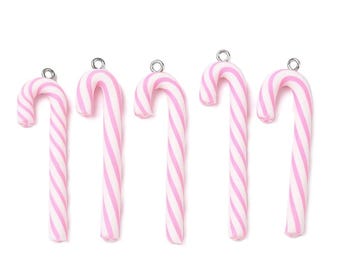May include: Five pink and white striped candy cane charms with silver-colored loops for hanging. The candy canes are curved and have a classic holiday design, perfect for crafting or seasonal decorations.