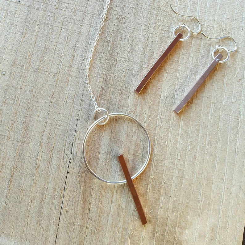 Beautiful 3-D copper bar necklace on sterling silver circle.