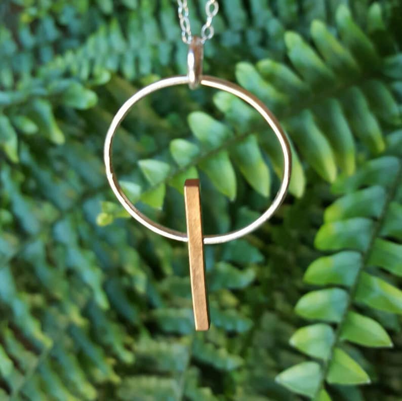 Beautiful 3-D copper bar necklace on sterling silver circle.