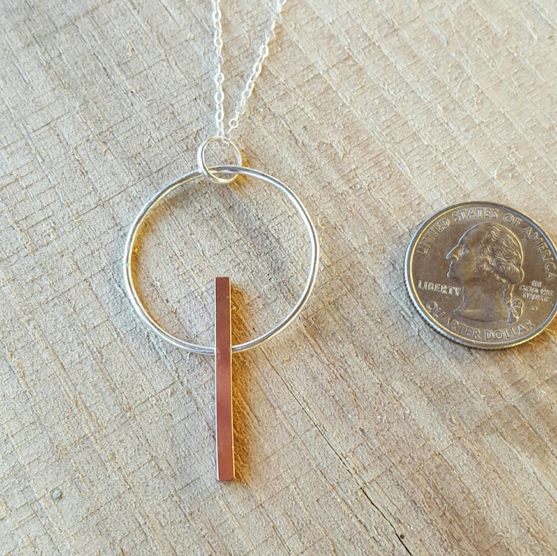 Beautiful 3-D copper bar necklace on sterling silver circle.
