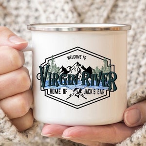 May include: White enamel camping mug with a black and green logo that says "Welcome to Virgin River, Home of Jack's Bar". The logo features a mountain range and a river.