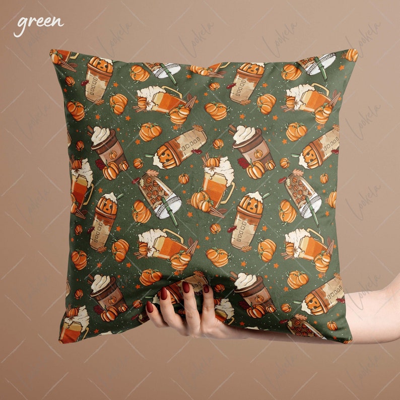May include: Green throw pillow with a fall-themed pattern featuring pumpkins, coffee cups, and cinnamon sticks.