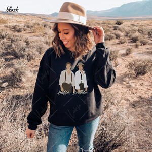 May include: Black sweatshirt featuring a graphic of two men wearing braces and the text "Hello, Brother."