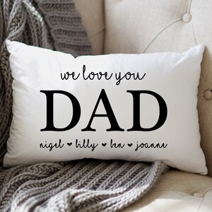 May include: White pillow with black text that reads "We love you Dad" with the names "Nigel, Billy, Ben, Joanne" underneath.