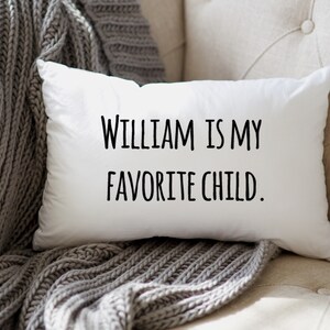 May include: White pillow with black text that reads "William is my favorite child."