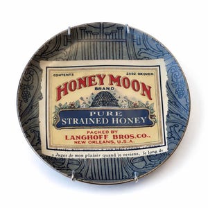 May include: A set of three ceramic canisters with lids, featuring a blue and white floral pattern. The canisters vary in size, suitable for kitchen storage. The design includes a detailed floral motif.