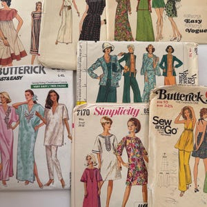 May include: A collection of vintage sewing patterns featuring illustrations of dresses, suits, and other garments. The patterns are from brands like Vogue, Butterick, and Simplicity. The covers display retro fashion designs and text.