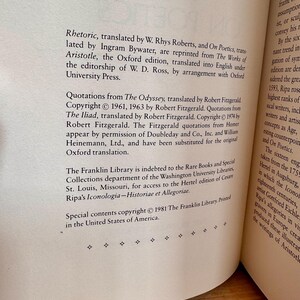 May include: An open book page featuring text from Aristotle's works, including "Rhetoric" and "On Poetics", translated by W. Rhys Roberts and Ingram Bywater. Copyright details for The Franklin Library are also present. The text is printed in black on cream-colored paper.