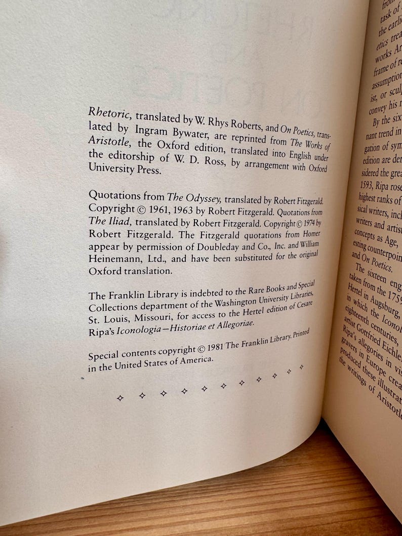 May include: An open book page featuring text from Aristotle's works, including "Rhetoric" and "On Poetics", translated by W. Rhys Roberts and Ingram Bywater. Copyright details for The Franklin Library are also present. The text is printed in black on cream-colored paper.