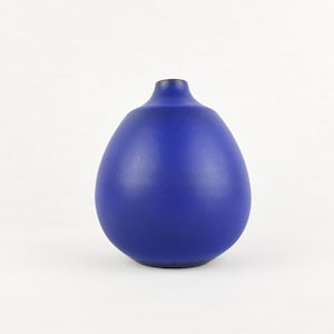 May include: A deep blue ceramic vase with a bulbous form and a slender neck. The vase has a smooth, matt finish and a simple, elegant design. This decorative vase is suitable for home decor.