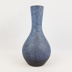 May include: A blue ceramic vase with a speckled glaze. The vase has a narrow neck and a rounded body.