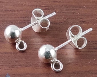 May include: Two silver earring posts with a small ball at the end and a loop for attaching a charm. The posts have a butterfly back.