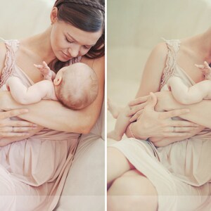 May include: A woman in a pink dress holds a baby in her arms. The baby is wearing a white onesie and has a soft, sleepy expression. The woman is looking down at the baby with a loving smile.