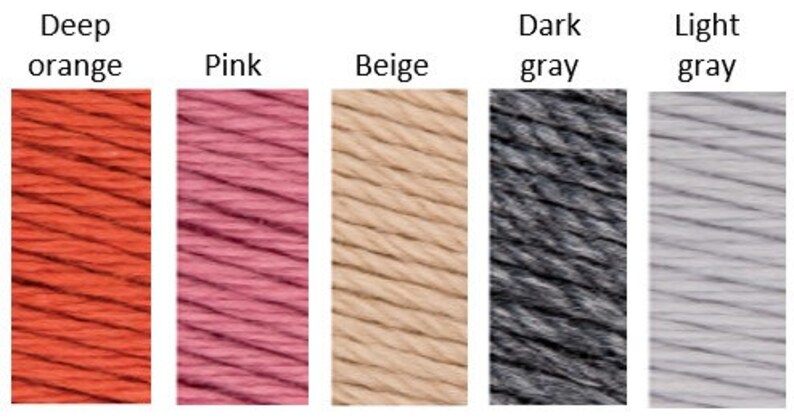 May include: Five yarn skeins in different colors: deep orange, pink, beige, dark gray, and light gray.