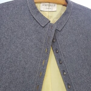 May include: A gray wool jacket with a yellow lining and a button closure. The label on the jacket reads "LEMPEREUR PARIS".