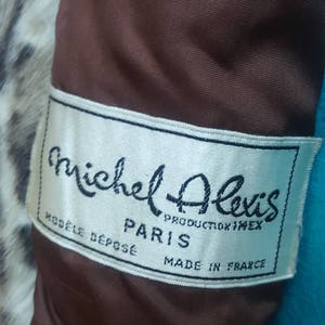 May include: White label with black text that reads "Michel Alexis, producteur imexe, Paris, Modele Depose, Made in France".