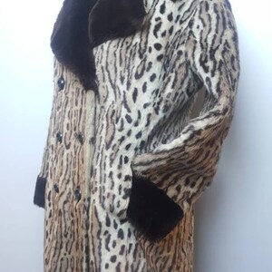 May include: A brown and tan leopard print fur coat with a brown fur collar and cuffs. The coat has a double breasted closure with black buttons.