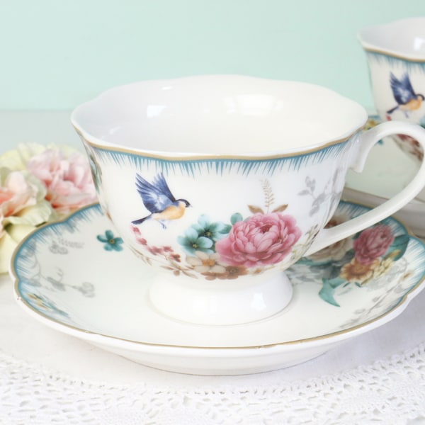 Beautiful tea cup and saucer with flowers and birds.