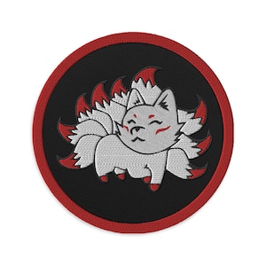 May include: Embroidered patch featuring a cartoon nine-tailed fox. The fox is white with red accents and a smiling expression. The patch has a black background with a red border, suitable for jackets, bags, or other fabric items.