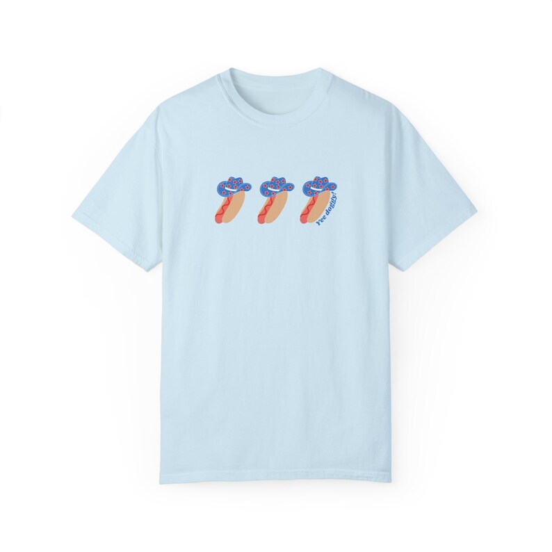 a blue t-shirt with a graphic 3 hot dogs with red, white, and blue cowboy hats