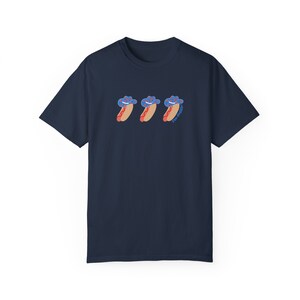 a navy t-shirt with a graphic 3 hot dogs with red, white, and blue cowboy hats