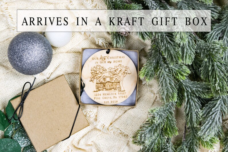 May include: A wooden Christmas ornament with the text "Our 1st Christmas in our new home" and the address "1234 Hemlock Street, Pine Grove, PA 17963, Est. 2019". The ornament is in a kraft gift box with a black ribbon.