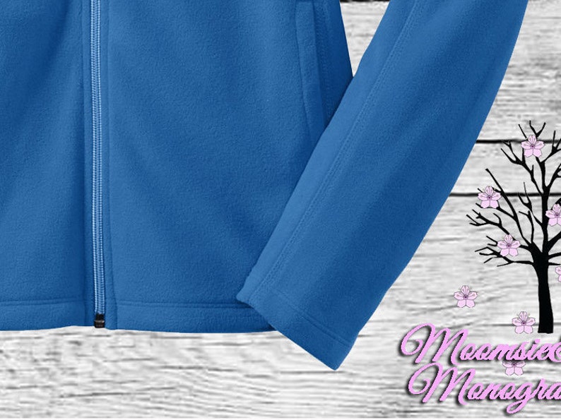 May include: A blue fleece jacket with a zipper closure and a white background.