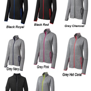 May include: Nine different color variations of a women's zip-up jacket with contrasting color trim. The jacket is made of a soft, comfortable material and features a stand-up collar, long sleeves, and two front pockets.