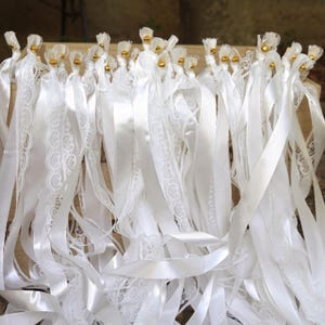 White lace ribbon wand with satin streamers for wedding send off.