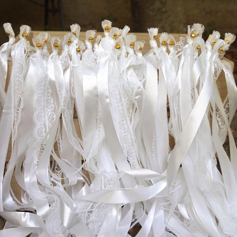 White lace ribbon wand with satin streamers for wedding send off.