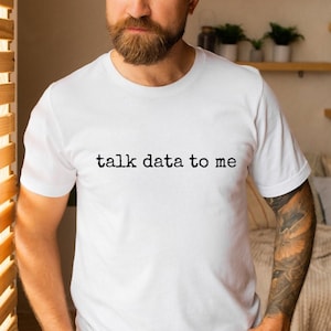 May include: White t-shirt with the text "talk data to me" printed in black.
