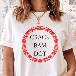 May include: White t-shirt with a red circle and the text "CRACK BAM DOT" inside.
