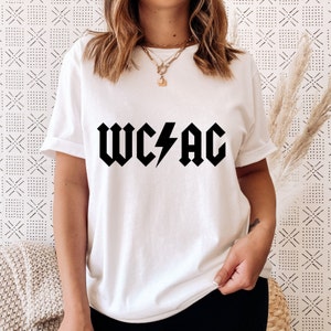 May include: White t-shirt with a black graphic of the text "WC⚡️AC" in a rock and roll font.
