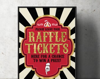 May include: A red and gold sign with a circus tent graphic and the text "Please leave your raffle tickets here for a chance to win a prize!" The sign has a black and white striped background.