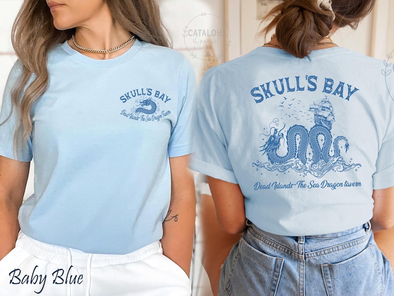 May include: Baby blue t-shirt with the text "SKULL'S BAY" and a dragon graphic on the front and back. The back graphic includes a ship and the text "Dead Islands - The Sea Dragon Tavern".