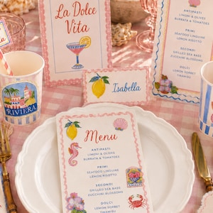 Coastal Italian party tableware mockup featuring watercolor clipart used on printable menu cards, place cards, paper cups, straw tags, napkins, and party decorations. Styled with pink gingham, lemons, shells, glassware, and pastel seaside details, perfect for showing invitation designs and printable party decor.