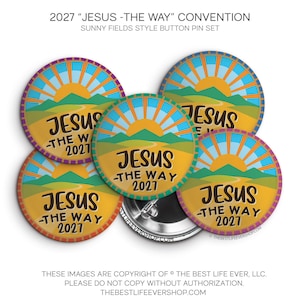 May include: A set of four circular button pins featuring a graphic of a yellow sun rising over green hills and a winding path. The text JESUS -THE WAY 2027 is printed in black on each pin. The pins have a colorful border and metal backs.
