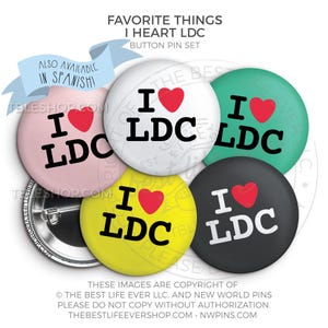 May include: Set of six 1-inch button pins with a white heart and the text "I heart LDC" in black. The buttons are in various colors: pink, white, green, yellow, and black.