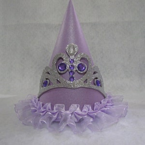 May include: A purple party hat with a silver glitter crown and a purple tulle ruffle around the bottom.