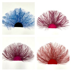 May include: Four feather fans in different colors. The fans are made of feathers and have a fabric base. The colors are blue, burgundy, burgundy, and orange.