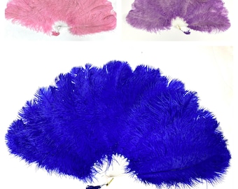 May include: Three feather fans in pink, purple, and blue. Each fan is made of soft, fluffy feathers and has a white handle with a tassel. The fans are spread open, showcasing their full, rounded shape. The background is plain white.