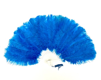 May include: A blue feather fan with a white handle. The fan is made of many feathers that are arranged in a circular shape.