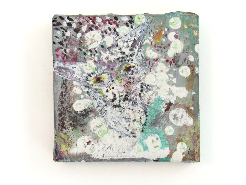 May include: Abstract painting on canvas with a white, gray, and green color scheme. The painting features a stylized animal face with a textured background.