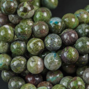 May include: A strand of green, brown, and white speckled round beads. The beads are made of natural stone and have a polished finish.