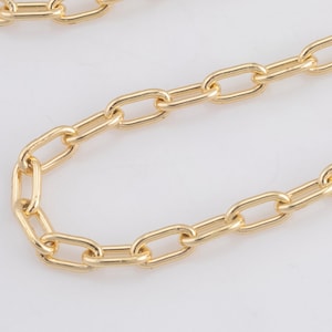 May include: A gold chain necklace with a classic oval link design. The chain is shown laid out flat on a white surface.