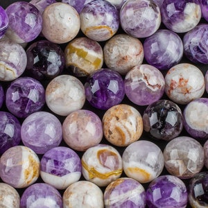 May include: A strand of round, purple amethyst beads with white and brown swirls. The beads are approximately 10mm in diameter.